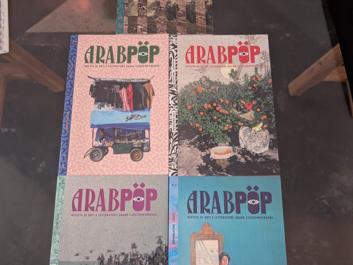 Four issues of Arabpop magazine displayed on a table