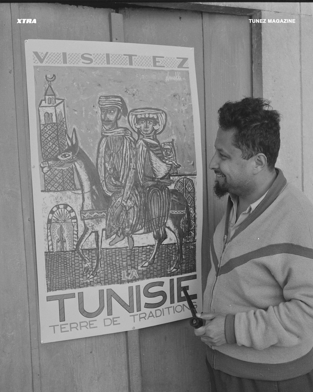 Hatem El Mekki beside his Visitez la Tunisie tourism poster