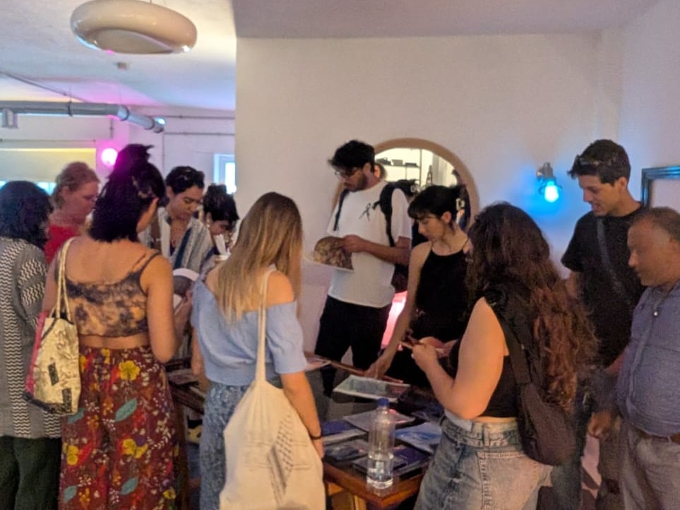 Visitors browsing publications on a table after the talk